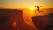 Silhouette of Enthusiastic man jumping between cliffs. Triumph in silhouette against sunset hues, nature's grandeur.