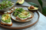 Fototapeta Krajobraz - Delicious toast with avocado slices, vegetarian toast with avocado, cream chese, tomato and microgreen
