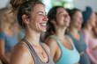 Group of expecting moms in a prenatal yoga class, smiling and practicing wellness