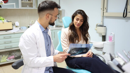 Wall Mural - Dentist and his patient working on planning treatment together