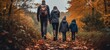 Rear view shot showcasing the joy of a family hike amidst the stunning colors of an autumn woodland.