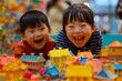 A joyful little Asian child delights in playing with a vibrant array of colorful block toys, creating a bustling town scene with boundless happiness. Generative AI.