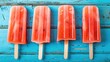 Fresh summer ice cream . Watermelon slice popsicles on a blue rustic wood background.