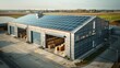 Aerial view of a modern warehouse with solar panels on the roof an aerial drone photo. Green energy concept in a rural area.