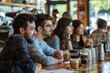 A candid shot capturing a group of individuals engaged in an animated discussion at a bar while sitting at a communal table