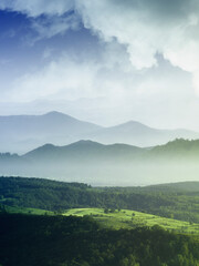 Wall Mural - idyllic landscape with mountains, green hills and mountains