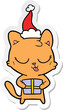 cute hand drawn sticker cartoon of a cat wearing santa hat