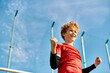 © LIGHTFIELD STUDIOS - A young boy in a vibrant red shirt stands confidently holding a baseball bat, ready to swing. His focused expression and strong grip indicate his passion for the sport.