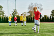 © LIGHTFIELD STUDIOS - A group of young men stands proudly on the soccer field, their silhouettes illuminated by the setting sun as they celebrate their victory.
