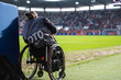 Disabled photographer in a wheelchair during football match