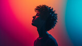 Fototapeta  - Silhouette of a Young Man Against a Vivid Red and Blue Gradient Background