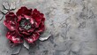 Red decorative volumetric peony flower on the background of a decorative wall.