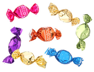 Wall Mural - Candies in bright wrappers falling on white background