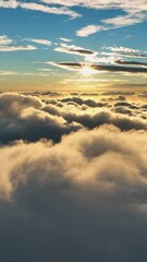 Wall Mural - Hyperlapse of sunrise over the clouds. Aerial shot of bright morning sun on blue sky above clouds. Great sunrise in the sky. Vertical Screen