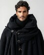 © Athena - A striking portrait of a handsome man with stylish curly hair wearing an elegant black textured coat and a turtleneck sweater against a neutral background.