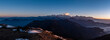 Panoramic of a mesmerizing skyline of a mountain range with snow-covered peaks against the blue sky