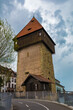 Great side view of the famous medieval Rhine Gate Tower (Rheintorturm), built around 1200 as part of the Constance city fortifications. This landmark stands between the old town and modern Constance.