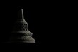 Miniature stupa made of temple stone with low key dramatic lighting