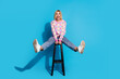 Full length photo of overjoyed eccentric girl wear pullover sit on bar chair astonished staring at sale isolated on blue color background