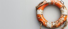 On A White Background, Grungy Lifebuoy Or Life Preserver With Rope Is Isolated