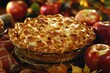 Freshly baked apple pie with a golden lattice crust, surrounded by raw apples and autumn decorations on a wooden table.