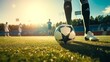 Soccer player steps on soccer ball for kick off in sunny stadium
