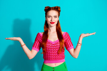 Wall Mural - Photo of funky cute lady dressed pink knitted shirt comparing arms emtpy space isolated blue color background