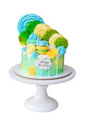 Wall Mural - Colorful green and yellow beautiful birthday cake on white background with lollipops and meringues on the top