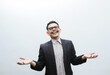 Waist-up portrait of glad and surprised handsome asian male office manager, raise hands sideways amazed and excited, see someone, hear great news and congratulating friend, white background