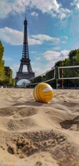 Wall Mural - Yellow volleyball on a sand court with the Eiffel Tower in the background during the day