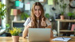 Girl sitting in the desk with a laptop on her lap showing thumbs up, green academia