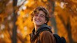 A candid snapshot capturing the joyous expression of a young college student amidst autumn foliage, resembling the style of National Geographic --ar 16:9 Job ID: 7200d599-06ea-46e8-ad47-8c9e2cadb70d