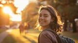 Fototapeta Kosmos - A candid shot of a college student smiling on campus during golden hour, evoking a sense of nostalgia and optimism, real photo, stock photography --ar 16:9 Job ID: 071dd774-f6fc-4ea9-bbf3-80c2d7428a67