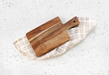 Wall Mural - Cutting board top view, kitchen wooden tray decorated with checkered folded cloth on white table.Food backdrop.