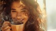 A happy smiling woman with messy curly hair savoring a smoking cup of coffee in the morning light