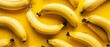   A bunch of ripe bananas sits atop a yellow counter, nearby rests an uncooked batch of unripe bananas