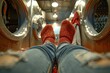 A cozy perspective of someone's feet up wearing red knitted socks, inside an industrial laundromat setting
