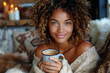 A beautiful dark-skinned girl with shaggy hair is holding a mug of coffee and smiling