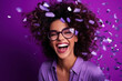 African American lady in 80s style clothes in sun glasses on nightclub with confetti isolated purple color background