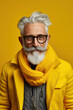 60 year old fashionable hipster man portrait on bright yellow background