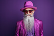 60 year old fashionable hipster man portrait on bright purple background