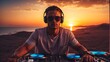 handsome dj playing at sunset, beach