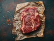 A top-down shot of a beautifully marbled ribeye steak seasoned and ready for the grill