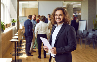 Wall Mural - Cheerful diverse business team at a corporate work meeting in the office. Banner with a group portrait of happy multiracial young and senior people all together smiling and looking at the camera