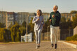 © Studio Romantic - Embracing an active sport, this happy senior couple finds joy in running and jogging together in a scenic city park. Smiles reflect the happiness derived from shared moments of run or jog.