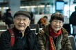 elderly couple waiting at the airport for a flight