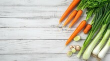 White Wooden Background With Fresh Vegetables, Carrots And Green Leeks On The Side And Space For Text, Flat Lay, Top View.