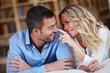 © peopleimages.com - Happy, woman and affection to husband at home in lounge for weekend away with love, trust and peace as partners. Married, couple and vacation for romance break, relax and bonding in safety of house