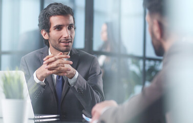 focused stylish millennial businessman consulting expert at the table