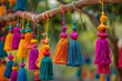 Close up shot of handcrafted decorative colorful wall hanging on occasion of Indian wedding. Wedding decoration at home in India. Handmade tassels hanging on tree. Party and wedding decoration concept